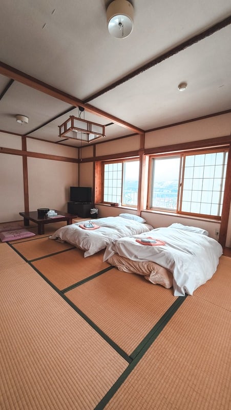 Traditional tatami room with futons at Yukiguma Lodge